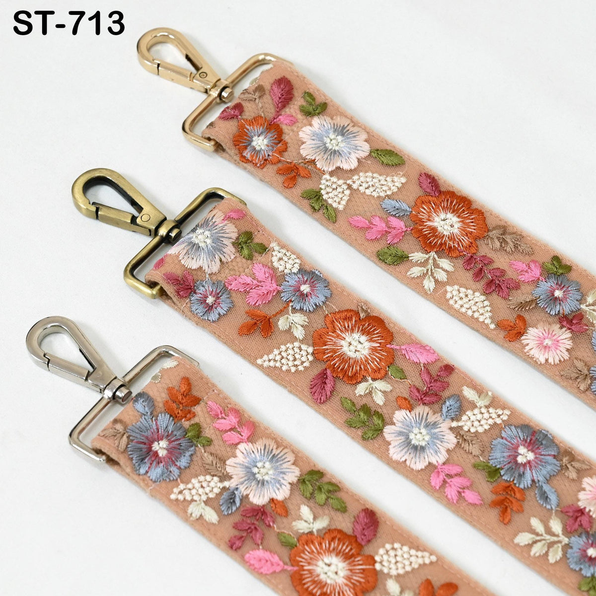 three colorful straps with floral embroidery, each featuring a metal clasp and hook.