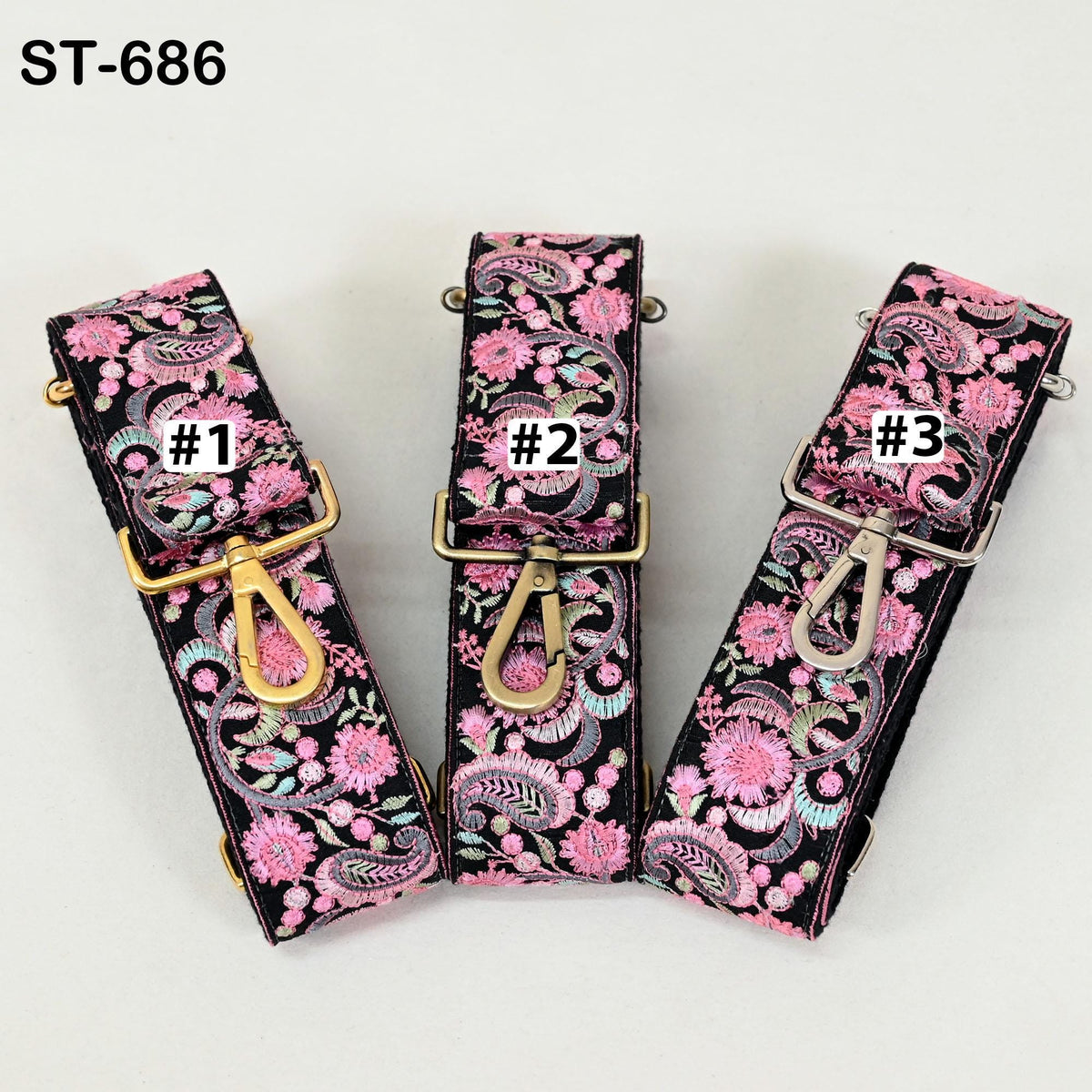 Three colorful straps with floral patterns, each with a different number printed on it.