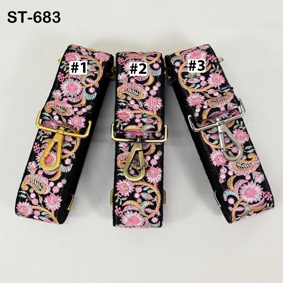 Three colorful floral straps with numbers on them, arranged in a row.
