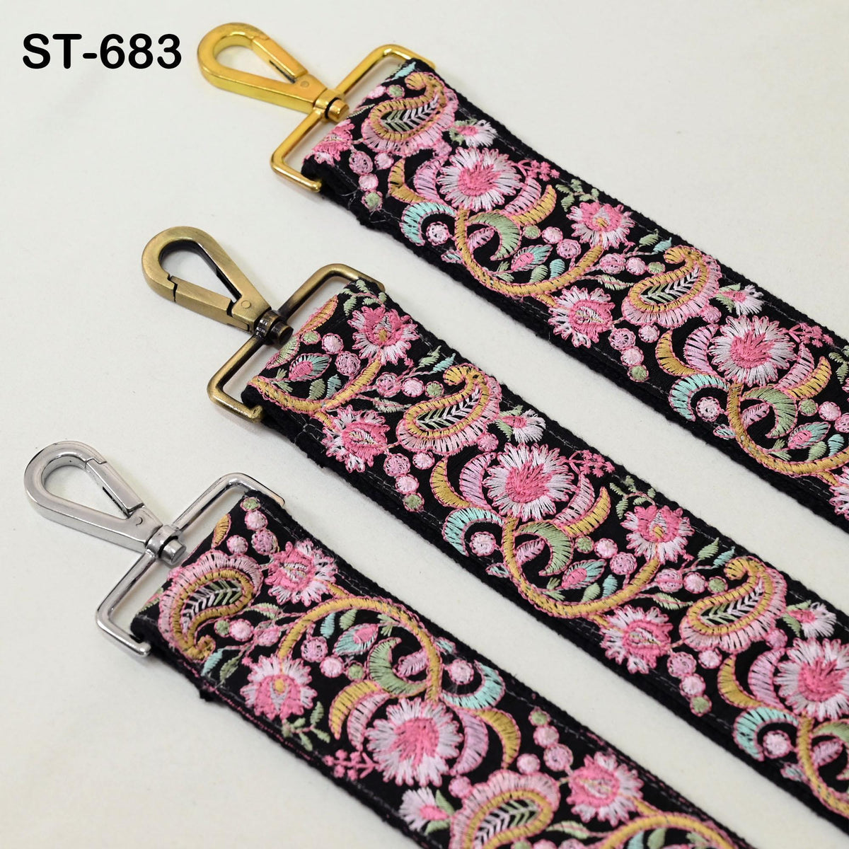 three colorful straps with floral patterns, each featuring a metal clasp and a gold-colored metal hook.