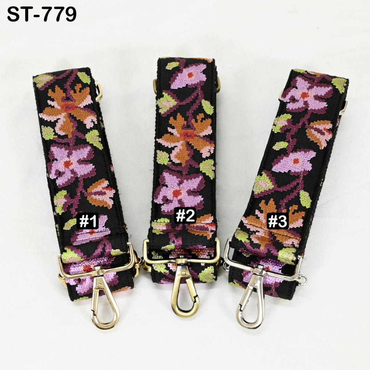 Three colorful floral straps with numbers on them, arranged in a row.