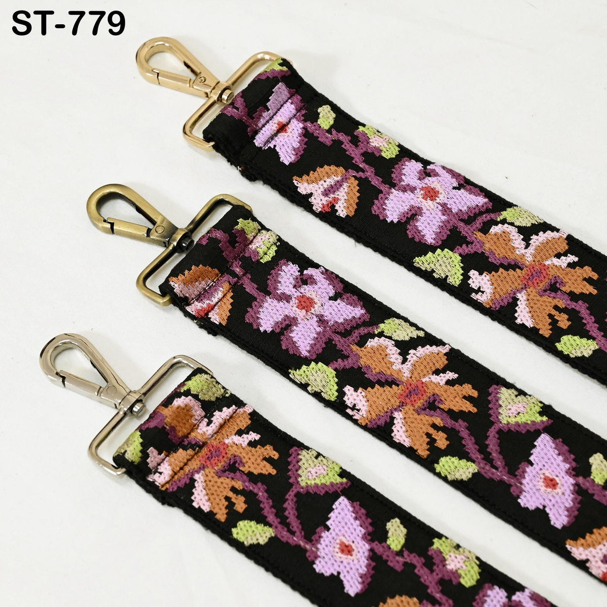 three colorful straps with floral patterns, each featuring a metal clasp and buckle.