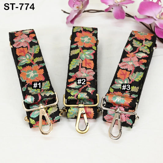 Three colorful floral straps with numbers 1, 2, and 3 printed on them, placed on a white surface with pink flowers in the background.