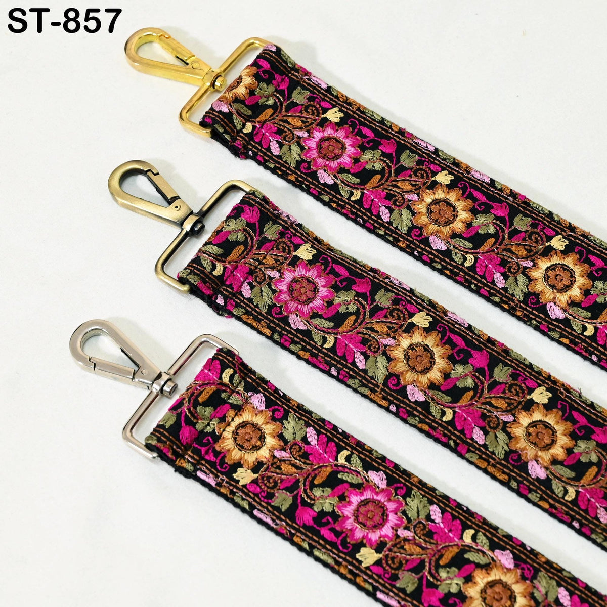 three colorful straps with floral patterns, each featuring a gold metal clasp and a silver metal hook.