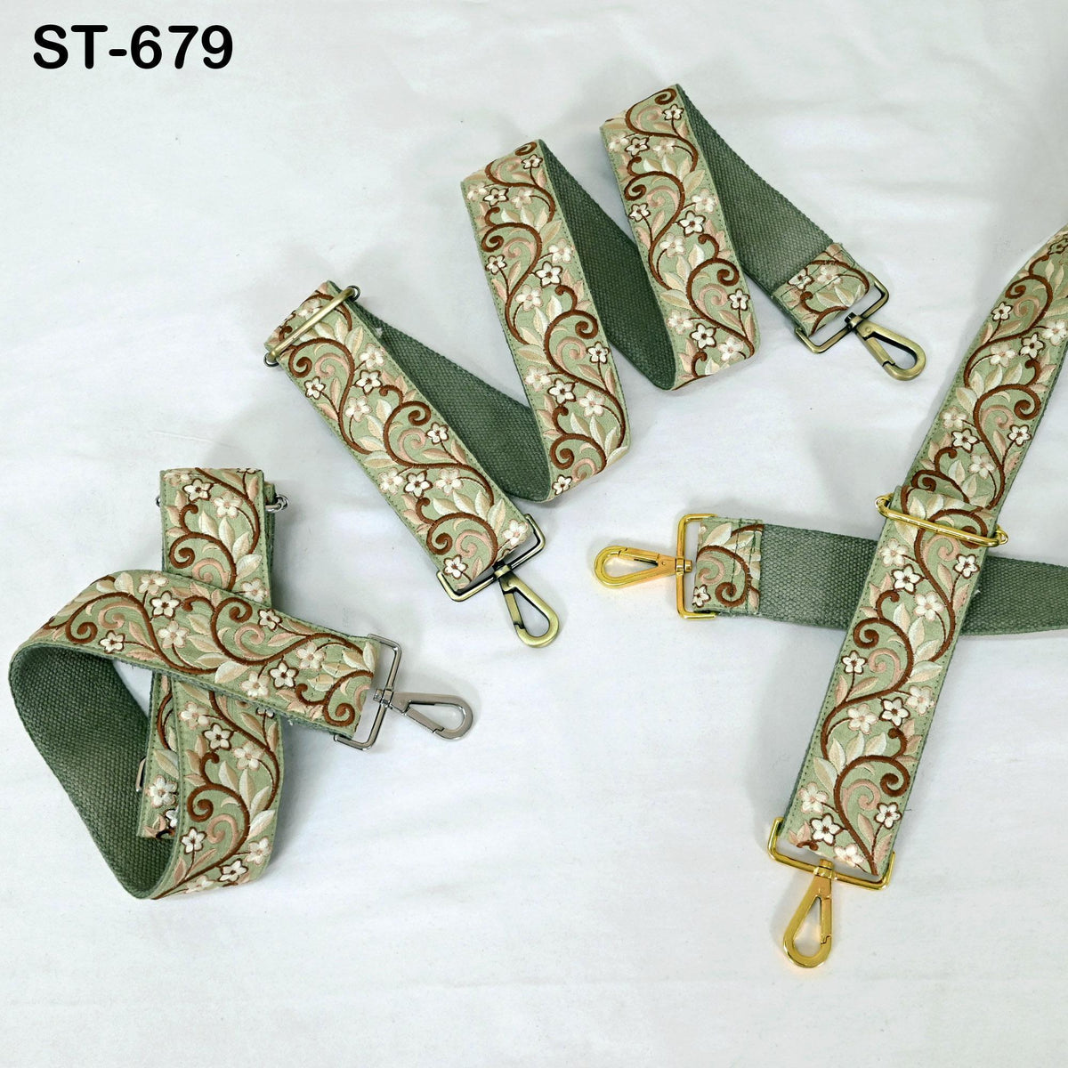 a collection of green and gold patterned straps, including a green strap with a floral pattern and a gold strap with a floral pattern, arranged on a white background.