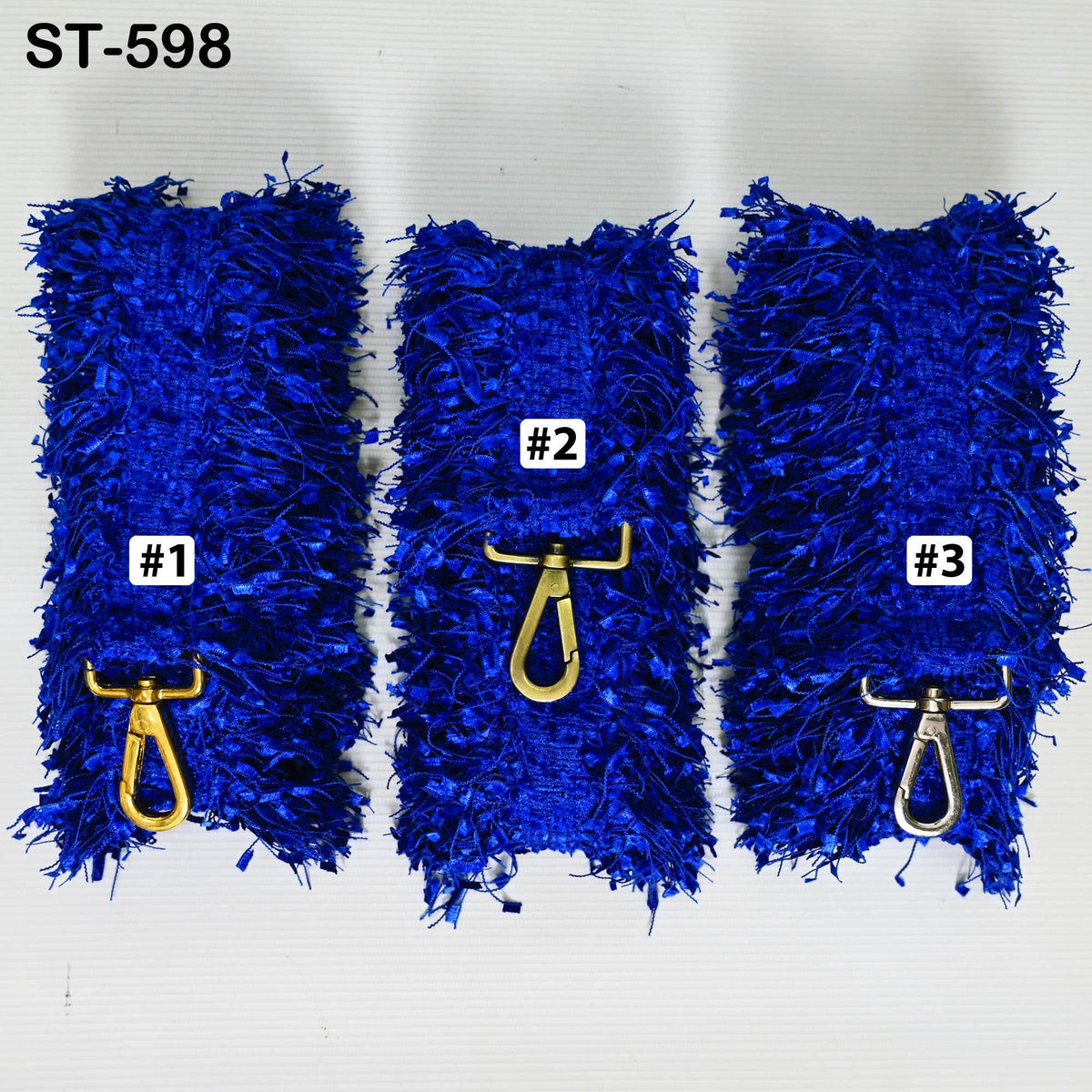 three blue fuzzy objects with gold hooks attached to them, arranged in a row.