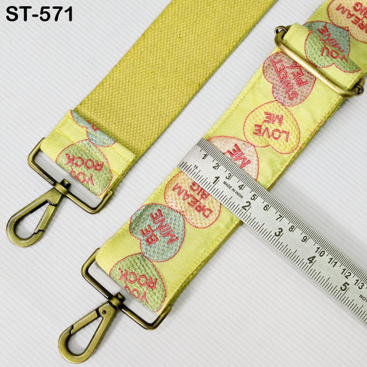 a yellow strap with a metal clasp and a ruler placed on top of it.