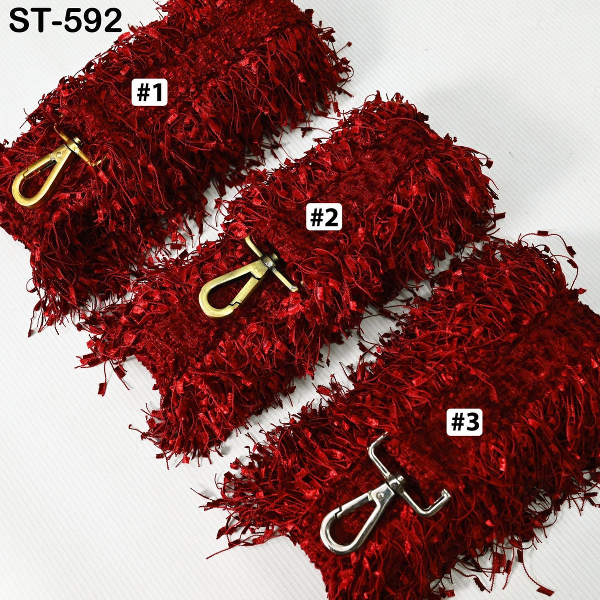 a collection of red, fluffy, and textured objects, possibly a type of fabric or material, with metal fasteners attached to them.