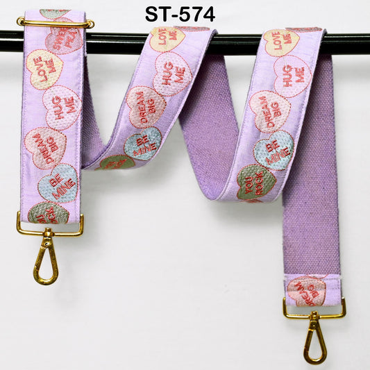 A purple strap with a heart-shaped embroidered pattern, featuring the words "LOVE ME" on it.