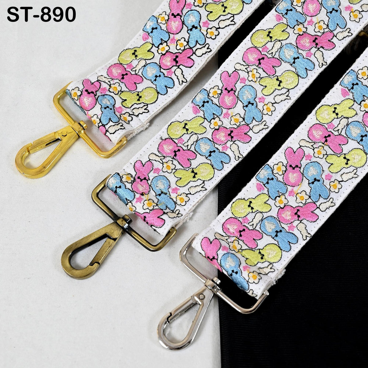 three colorful straps with a floral pattern, each with a metal clasp and hook.