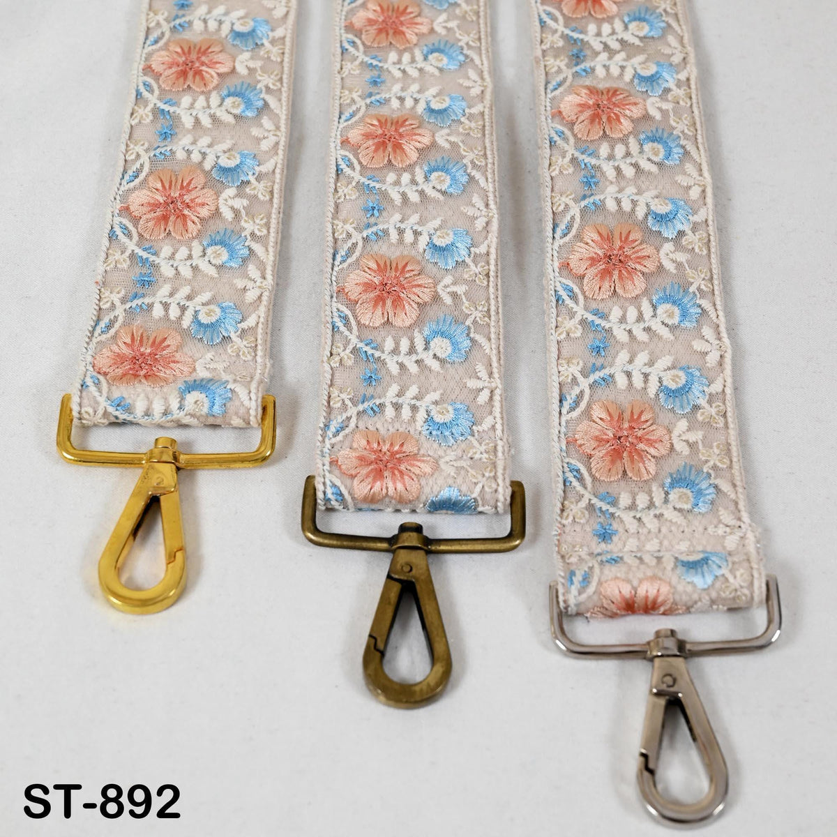 Three colorful straps with floral patterns, each featuring a metal clasp and hook.