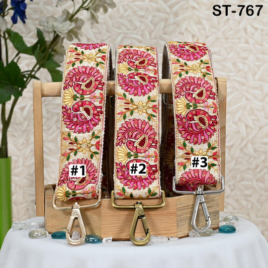 Three colorful straps with floral patterns, each with a different number printed on it, displayed on a wooden stand.