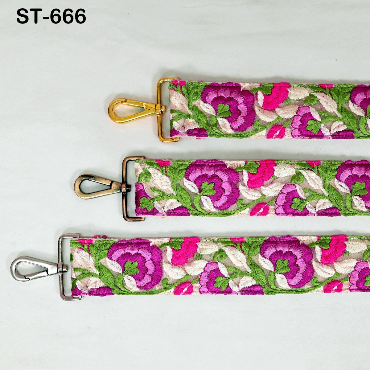 three colorful straps with floral patterns, each featuring a metal clasp and hook.
