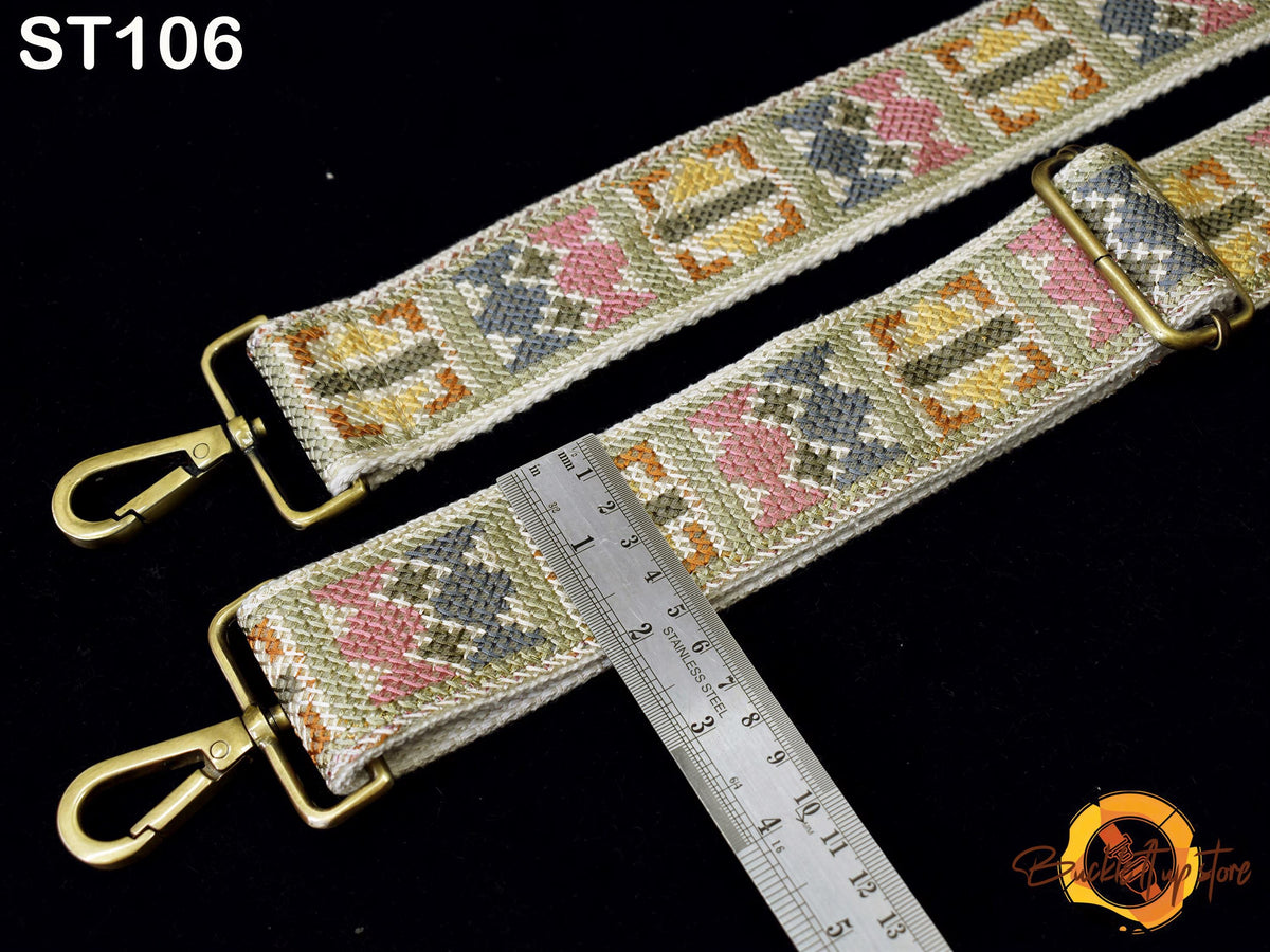 a colorful, patterned strap with a metal clasp and a ruler placed next to it, indicating the strap's size.