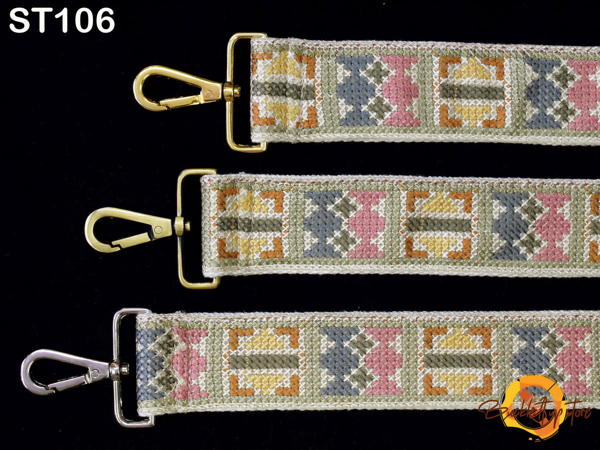 three straps with different patterns and designs, including a gold-colored metal buckle and a cross-stitch pattern.