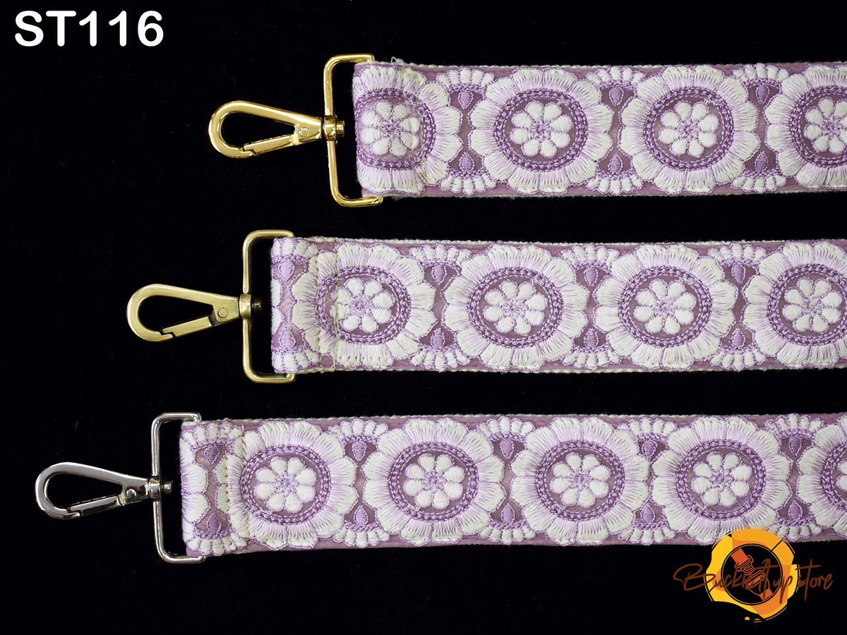 three straps with a floral pattern in shades of purple and white. The straps have a gold metal buckle and a silver metal attachment.