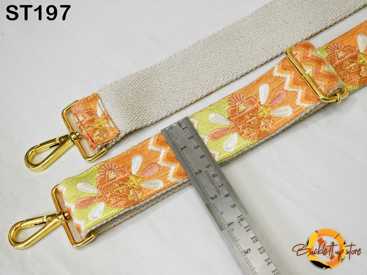 a strap with a floral pattern and a ruler placed next to it, indicating the strap's size.