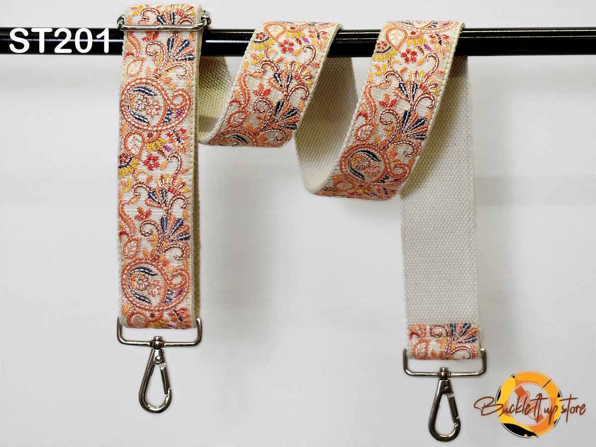 a pair of colorful, patterned straps hanging on a black bar.