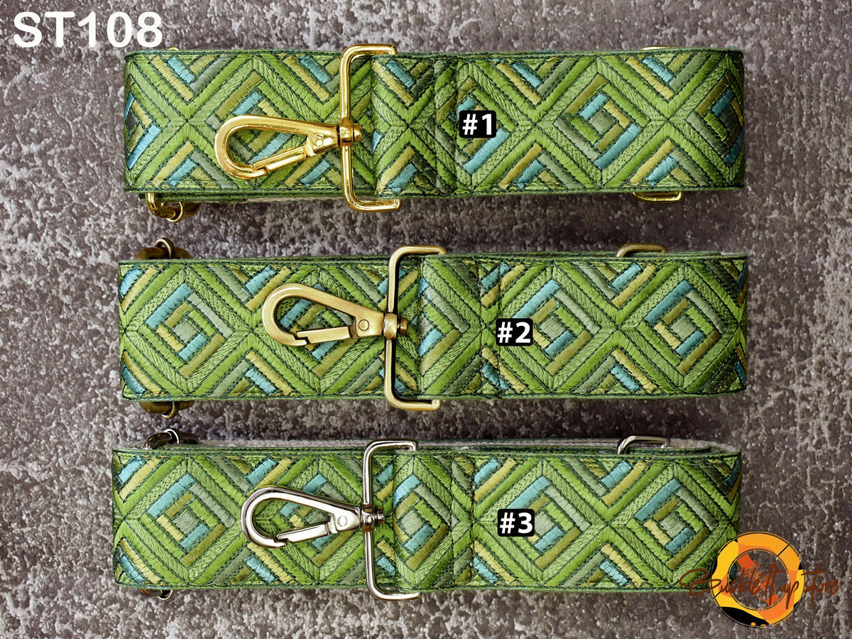 three green and gold patterned straps with metal buckles, arranged in a row.