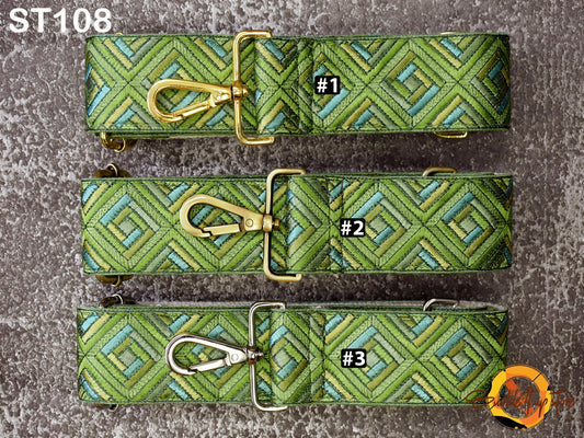 three green and gold patterned straps with metal buckles, arranged in a row.