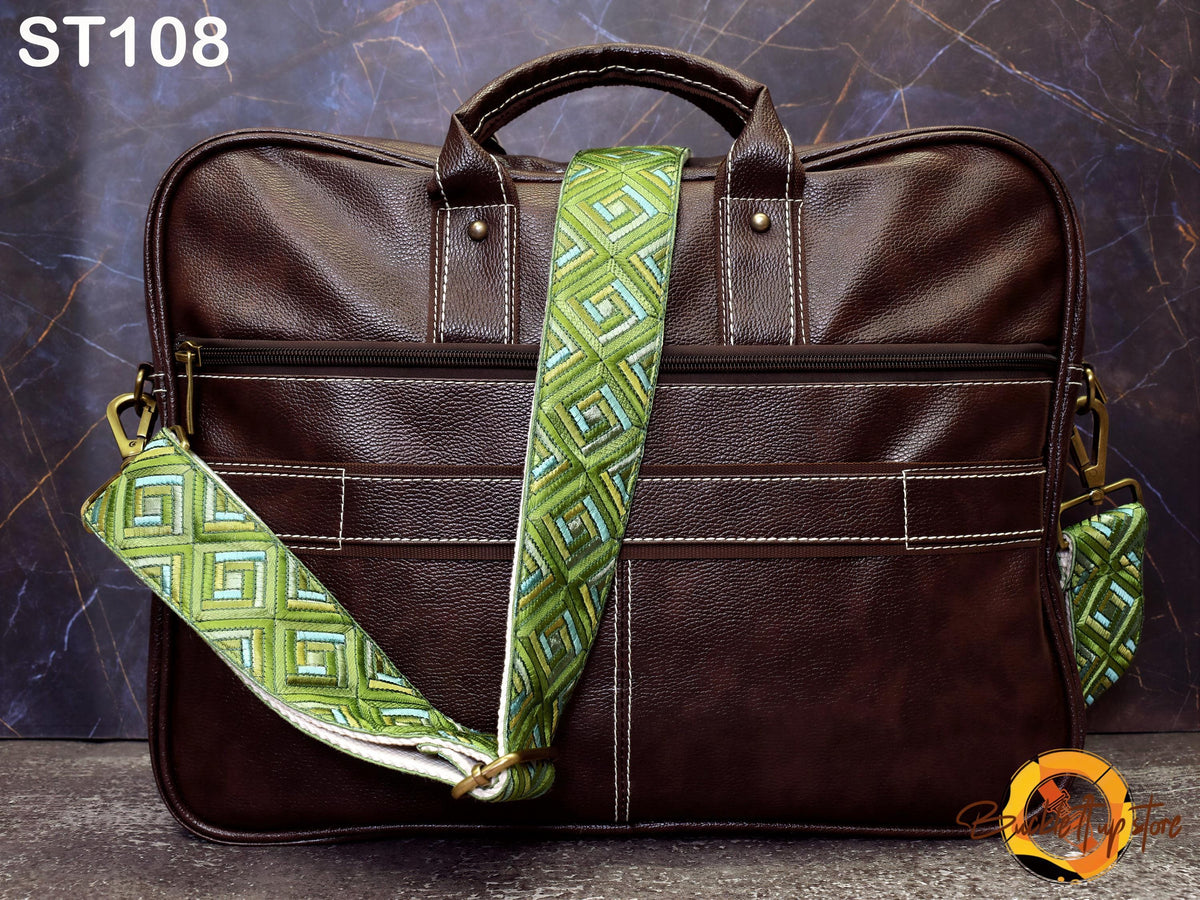A brown leather briefcase with a geometric patterned strap, placed against a dark background.