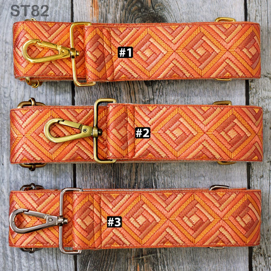 three straps with different patterns, arranged on a wooden surface.