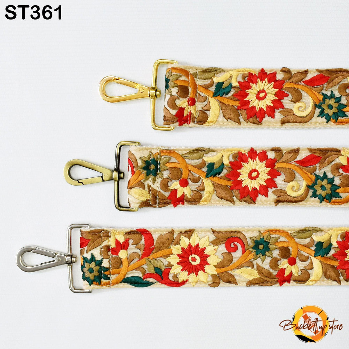three straps with floral embroidery in red, yellow, and green colors. The straps have metal buckles and hooks, and the straps are arranged in a row.