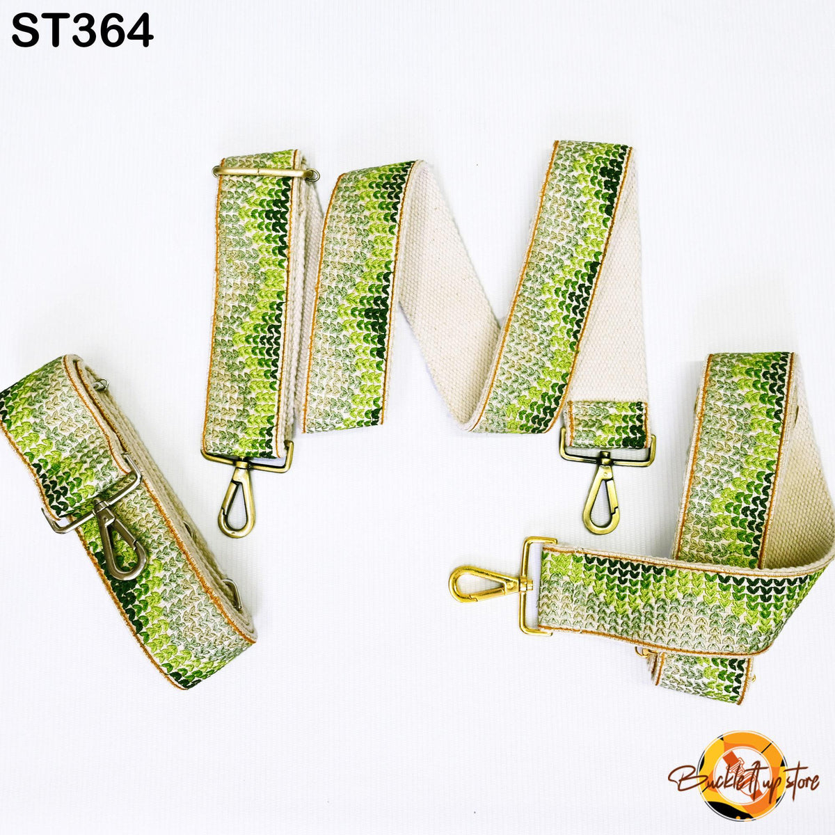 a collection of green and white patterned straps, likely designed for use as a crossbody bag strap.