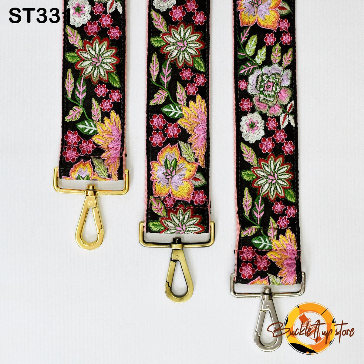 Three colorful floral straps with gold buckles, arranged in a row against a white background.