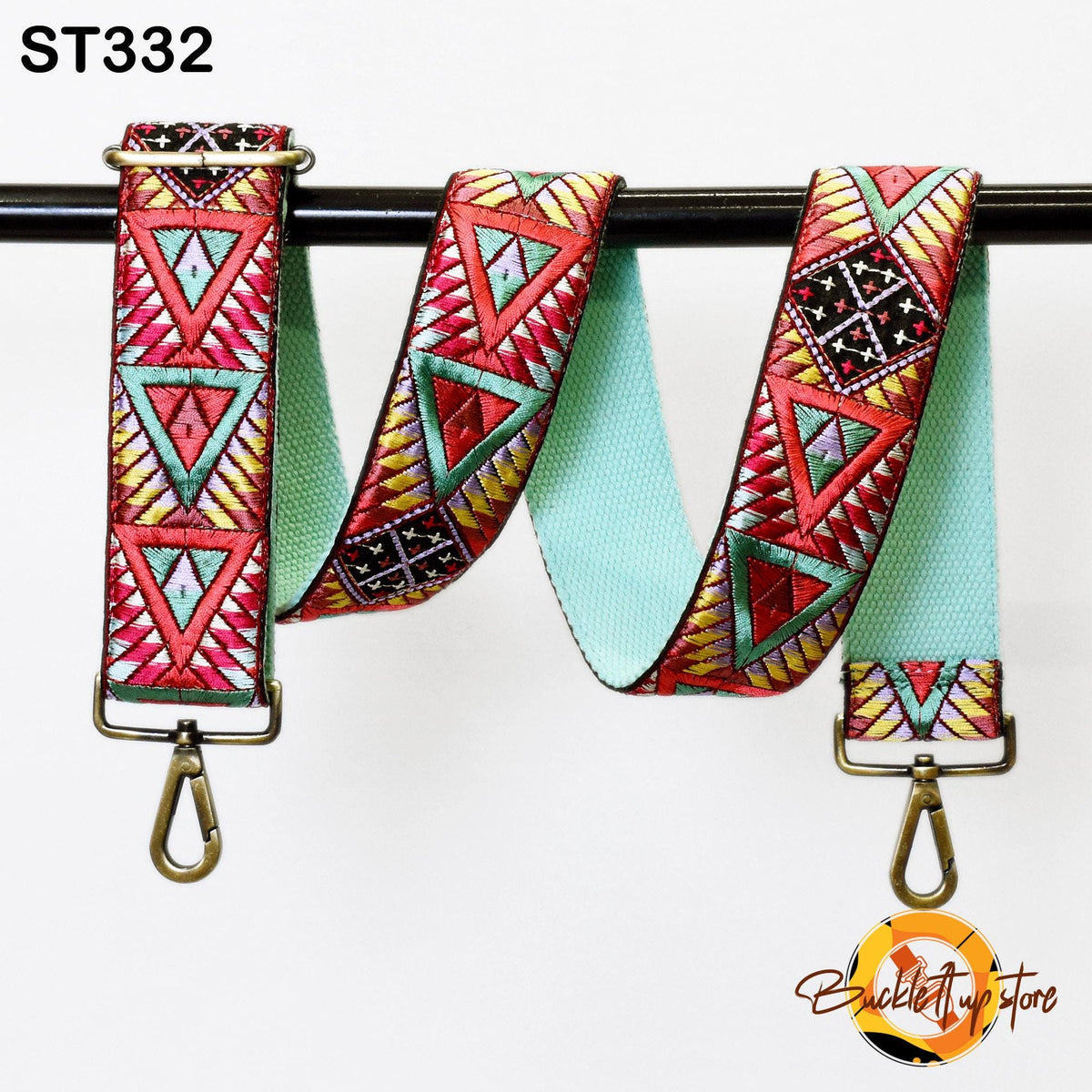 A colorful, patterned strap with a geometric design, hanging from a hook.
