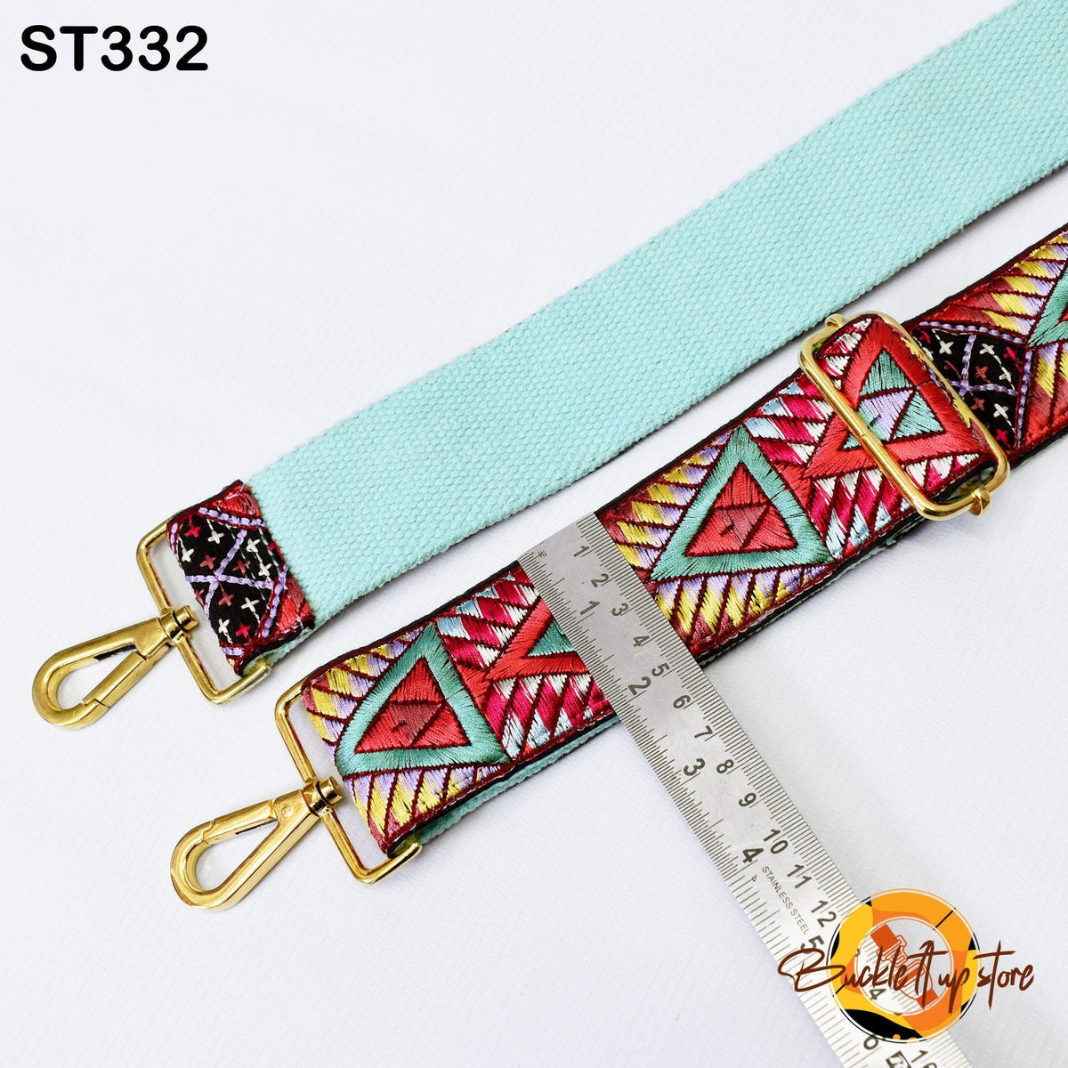 a turquoise strap with a colorful geometric pattern, and a ruler is placed next to it, indicating the strap's size.