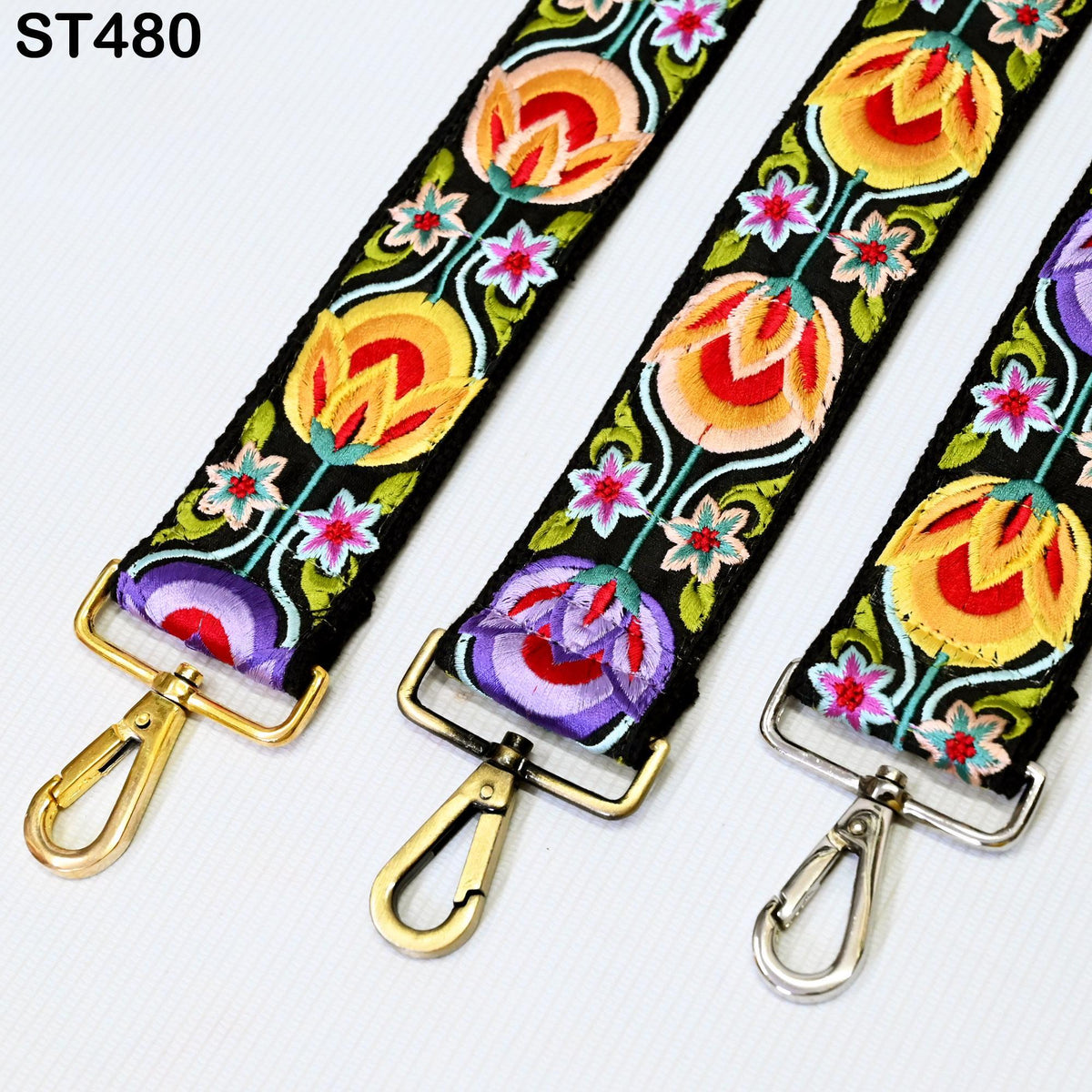 three colorful straps with floral designs, each with a metal clasp and hook.