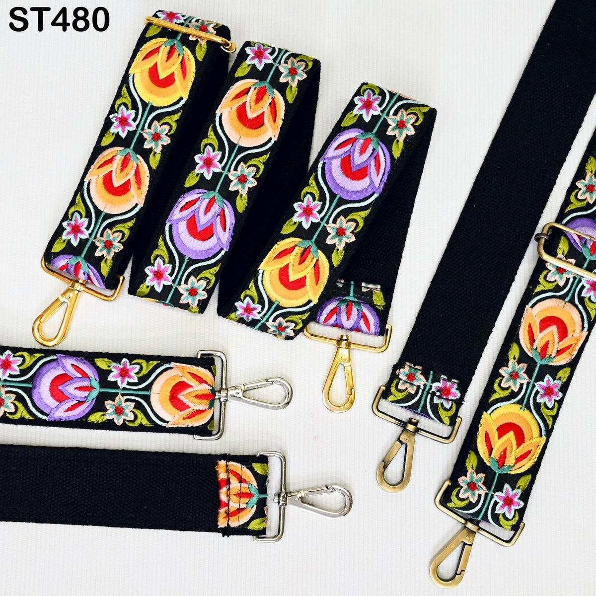 a collection of colorful, patterned straps with floral designs, including black straps with gold hardware.