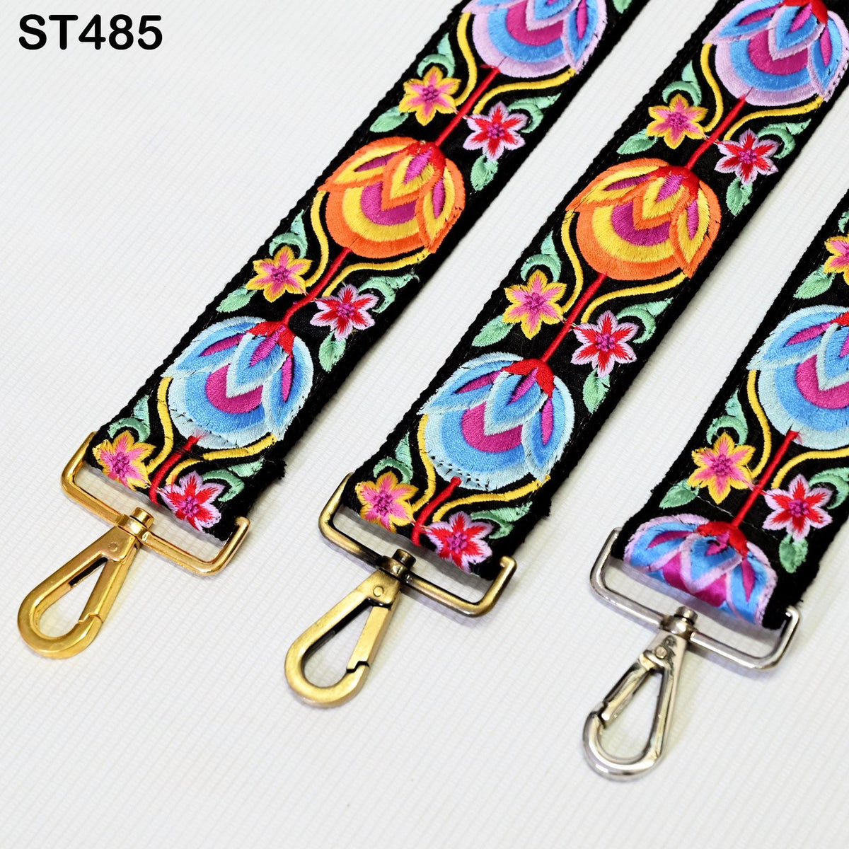 three colorful straps with floral patterns, each featuring a gold-colored metal clasp.