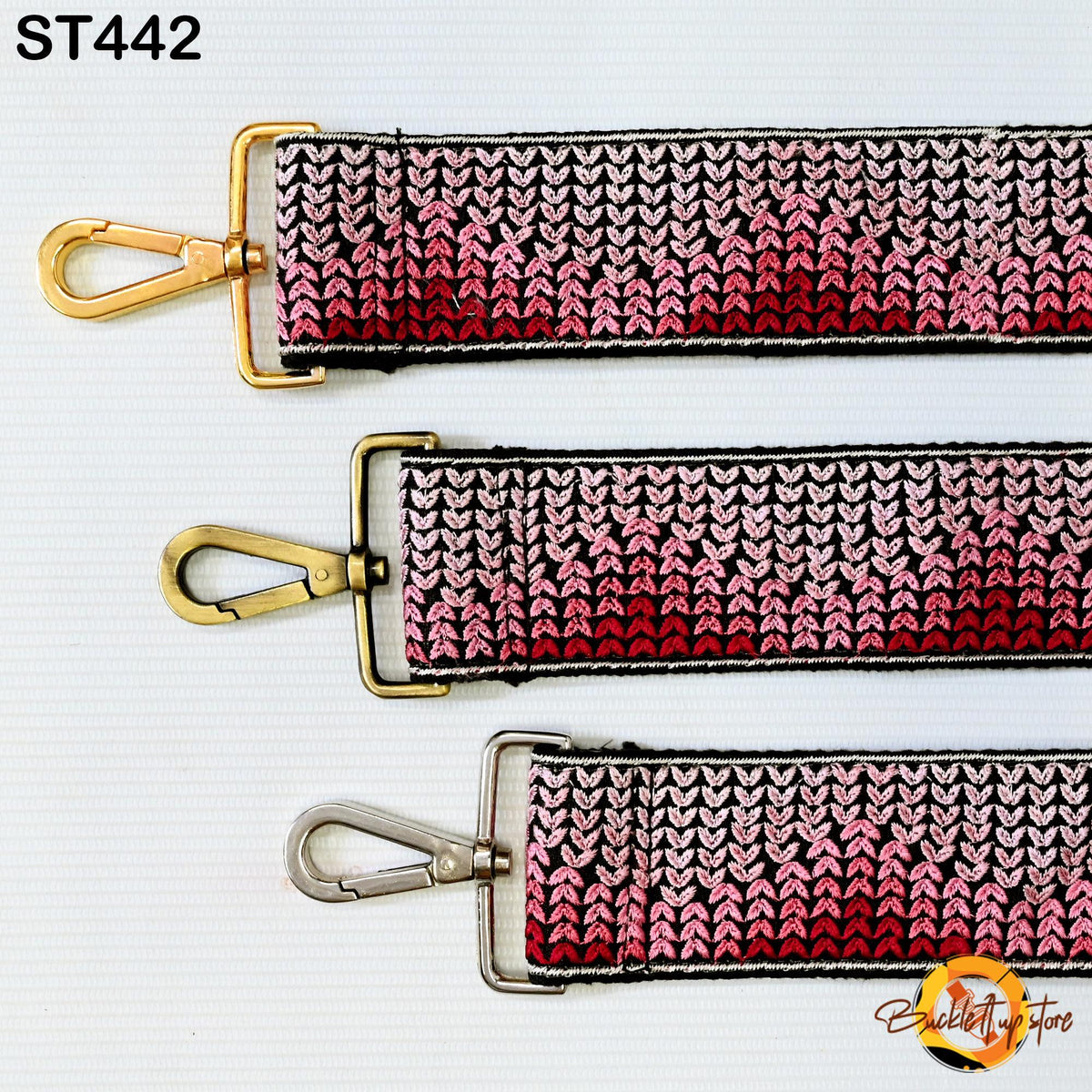 three different straps with a knitted or crocheted pattern in shades of pink and red. The straps appear to be made of a material that resembles crochet or knitting.