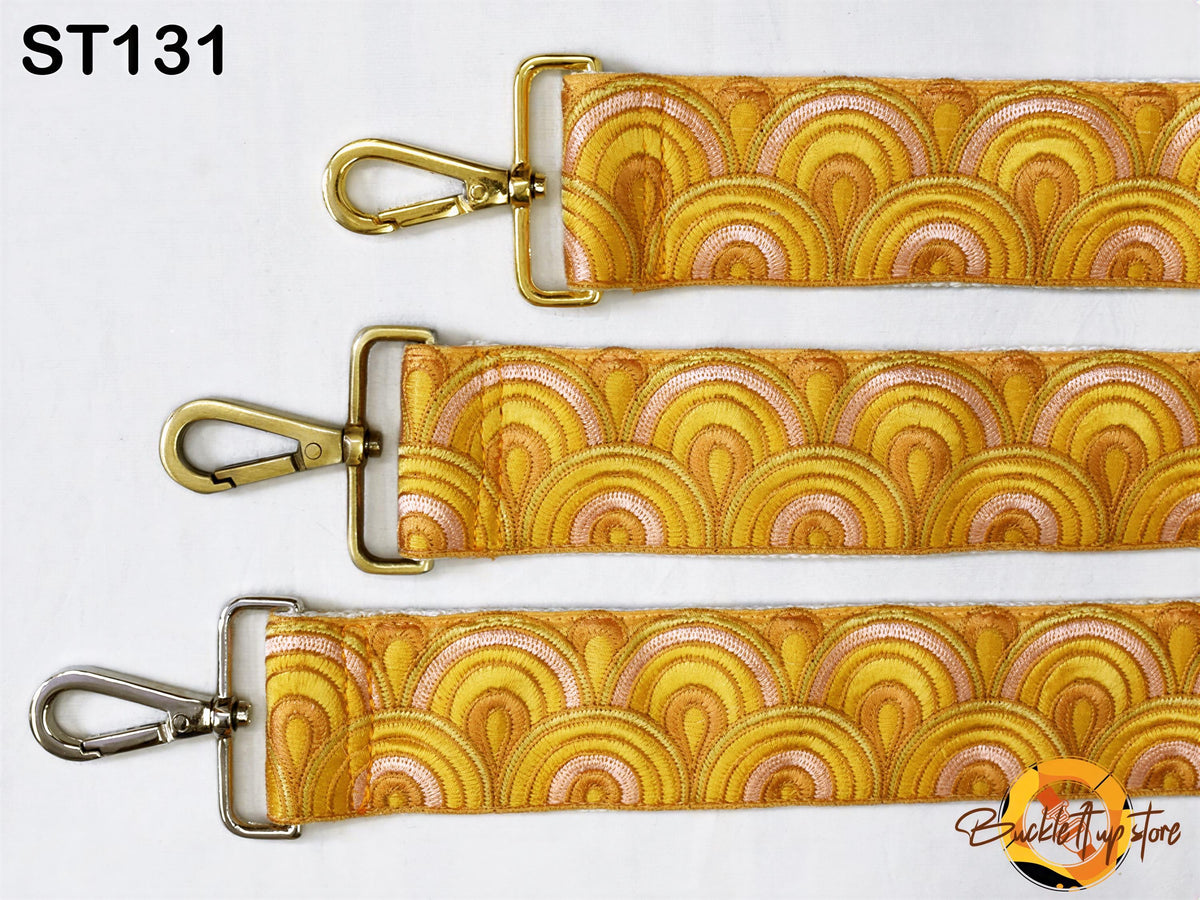 three straps with a yellow and orange wave pattern, each with a metal clasp and hook.