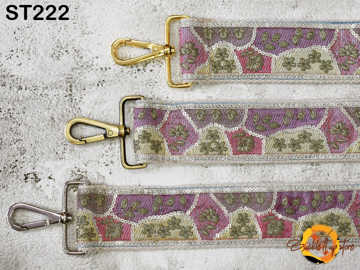 three straps with different patterns and designs, including floral and geometric patterns, laid out on a white surface.