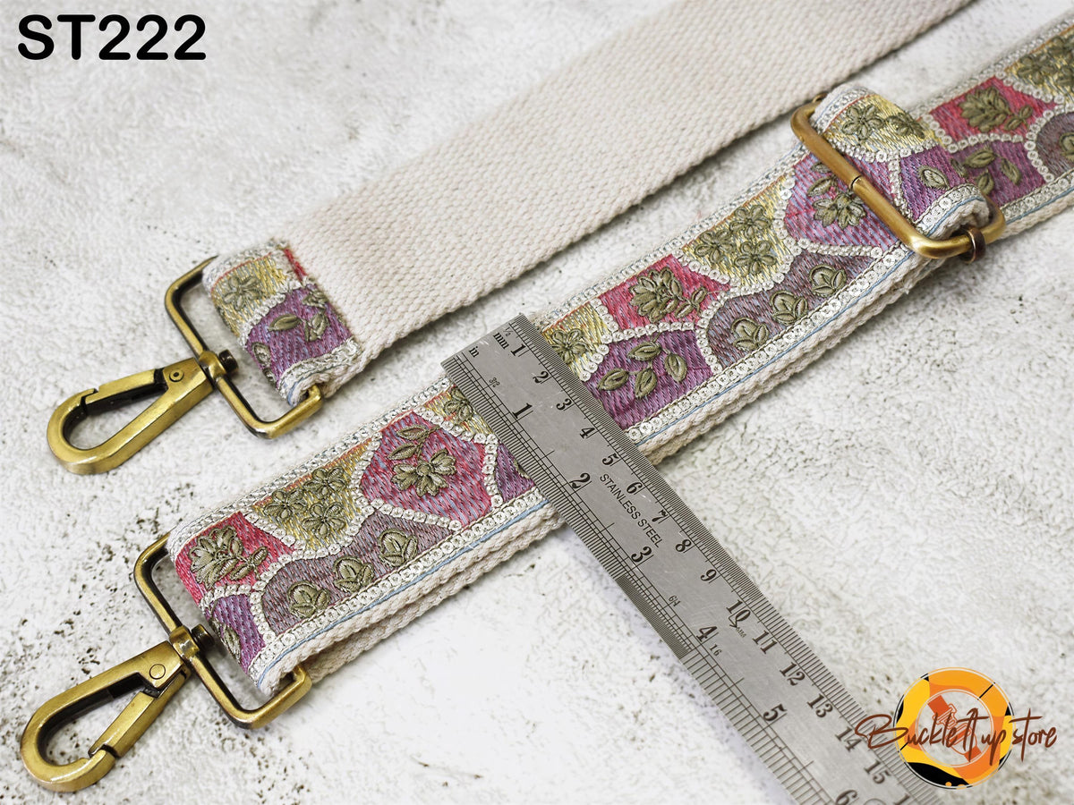 a colorful strap with a metal ruler placed on top of it, indicating the strap's length.