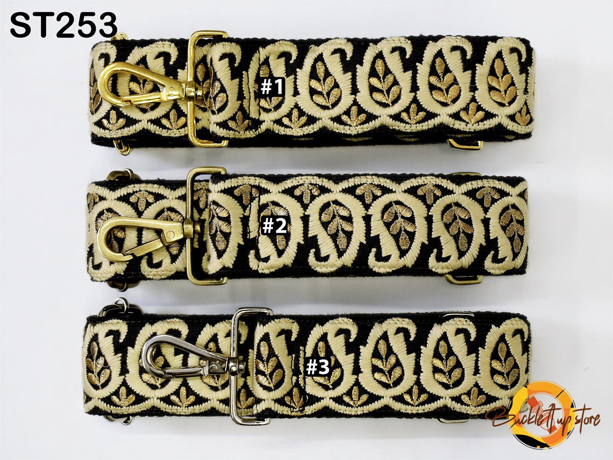 three straps with a decorative pattern in gold and black colors. Each strap has a unique number attached to it, indicating the individual strap.