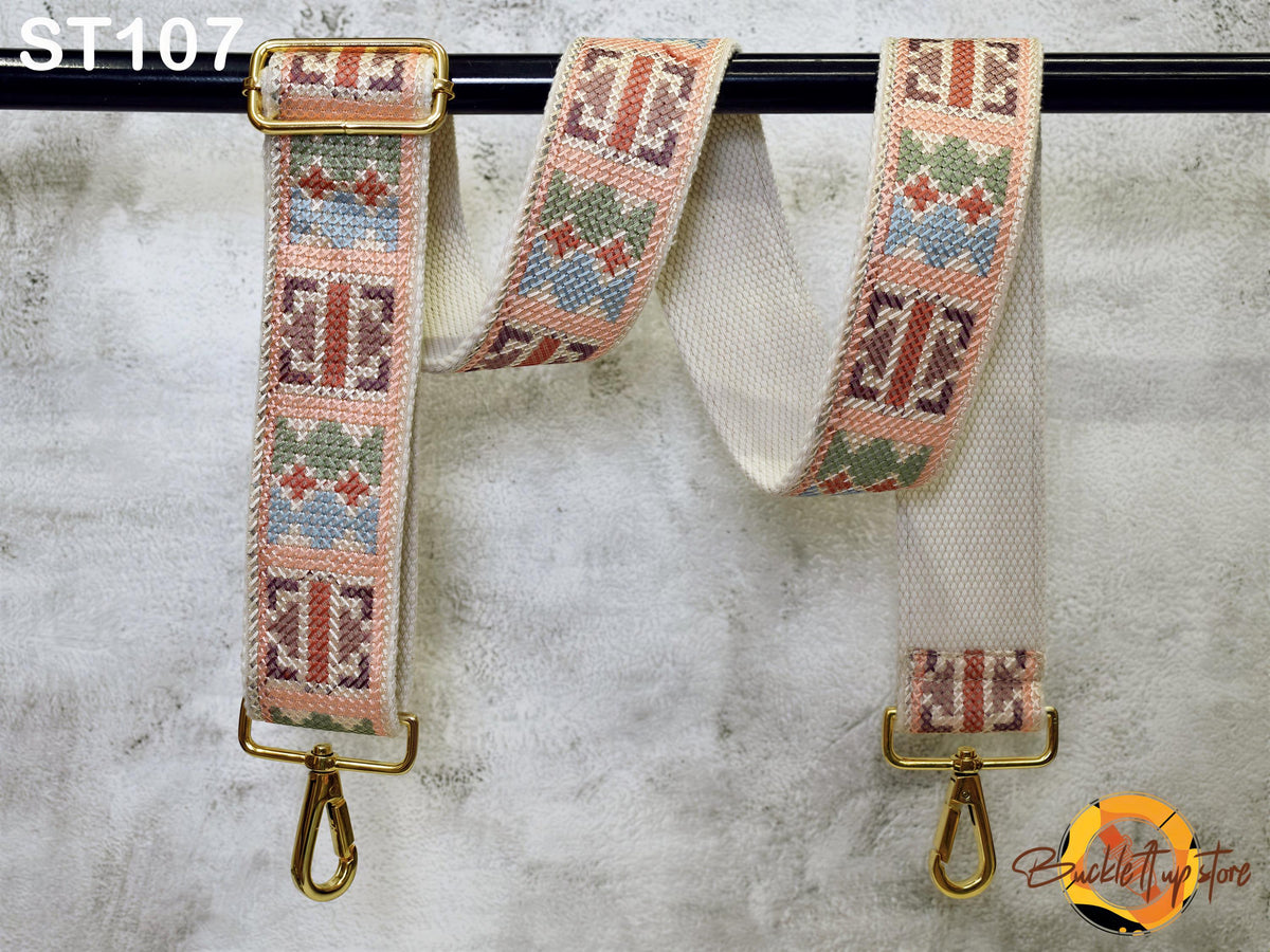 a pair of colorful, patterned straps hanging on a black bar.