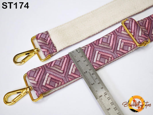 a strap with a geometric pattern in shades of pink and purple, and a ruler is placed next to it, indicating the strap's size.