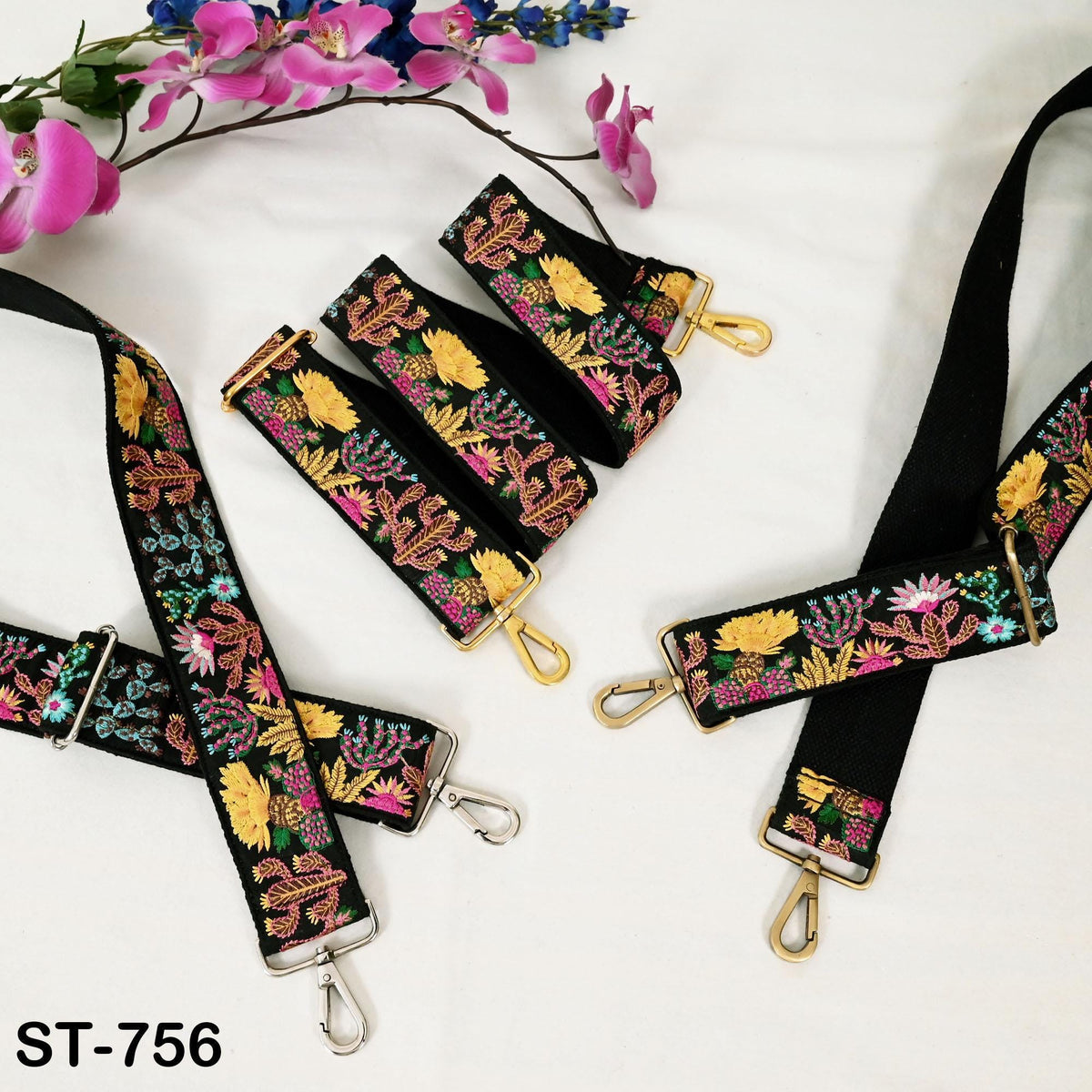 a collection of colorful, embroidered straps with floral patterns, arranged on a white background.