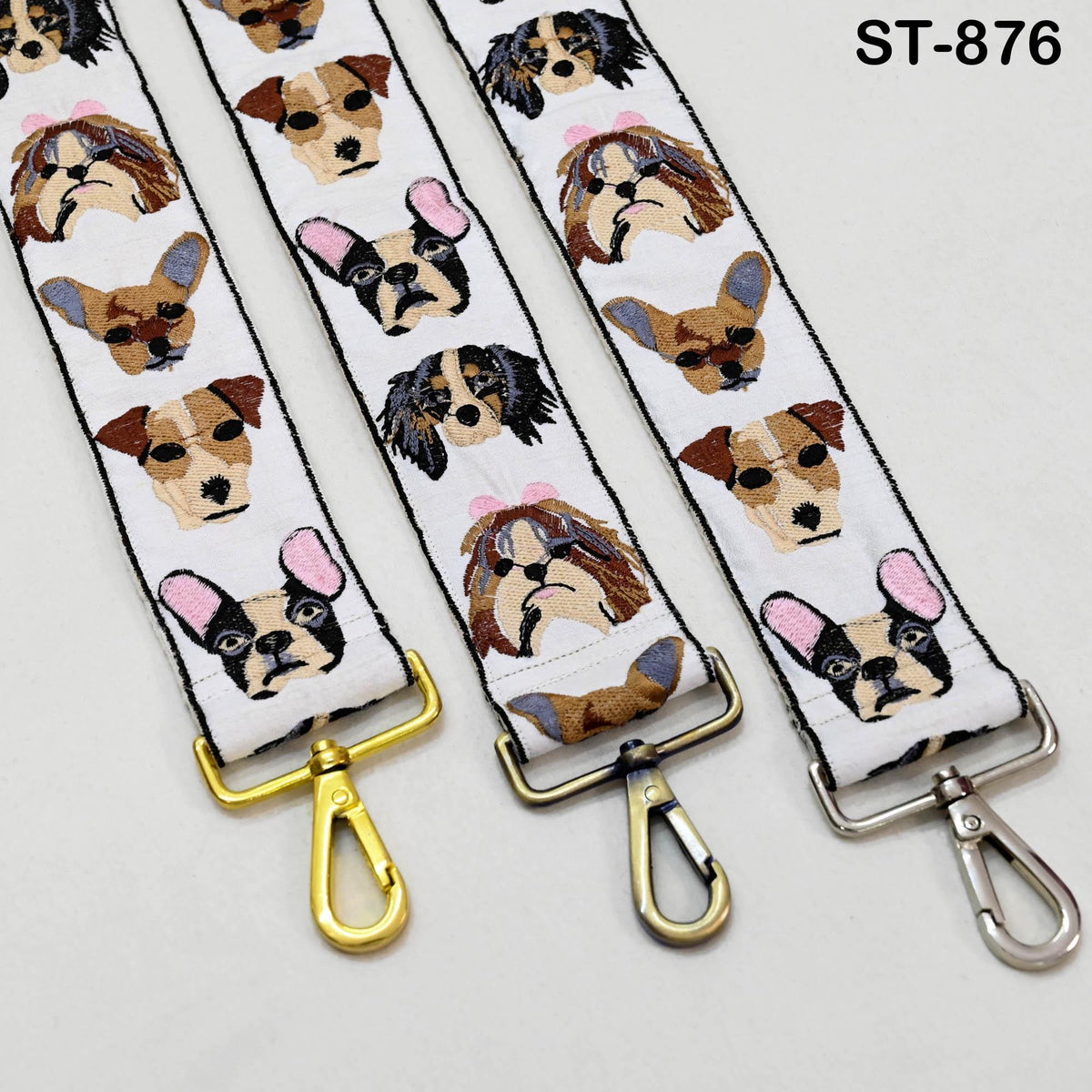three straps with dog faces printed on them, each with a metal clasp at the end.
