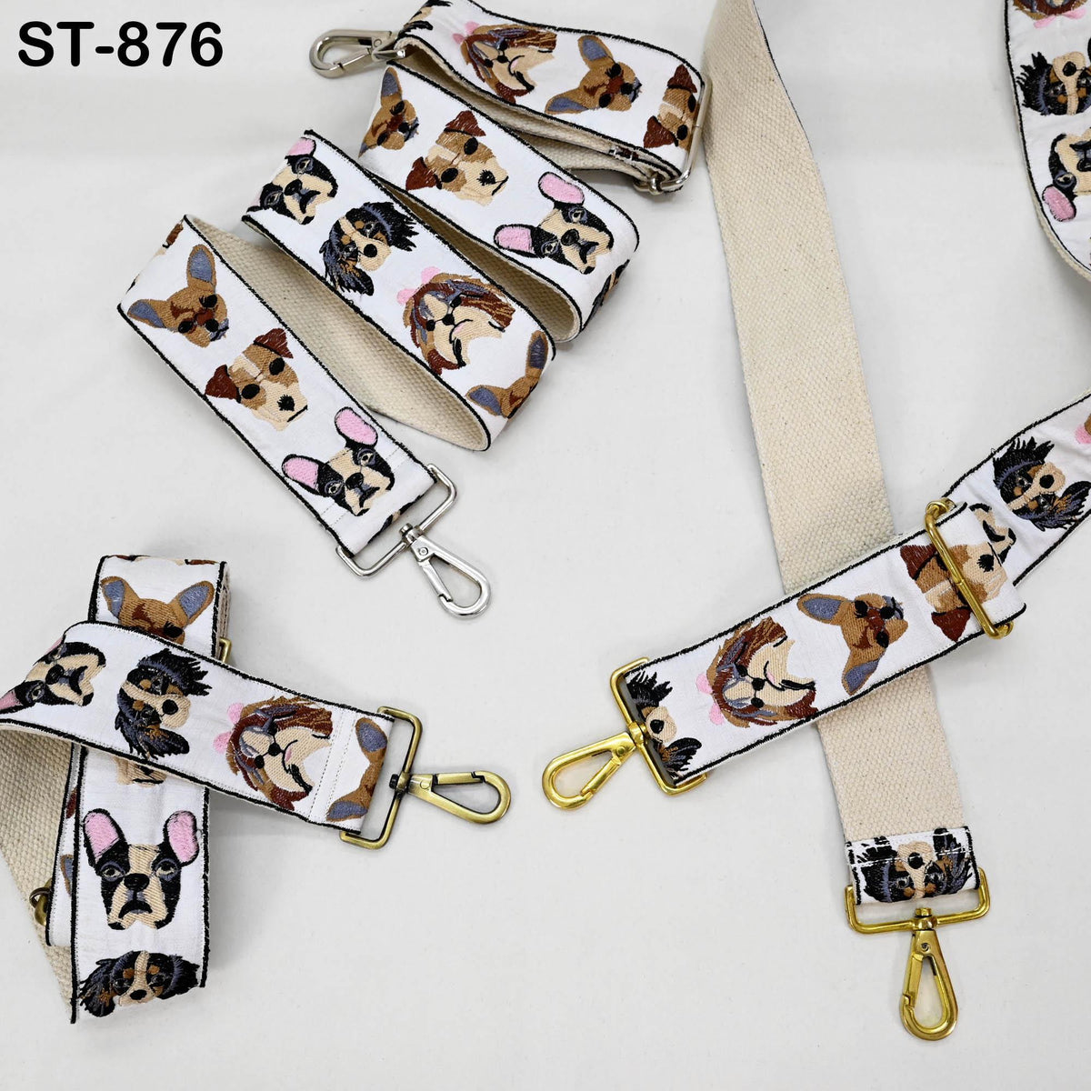 several straps with a pattern of dog faces on them. The straps are arranged on a white background, with some of them attached to a strap loop.