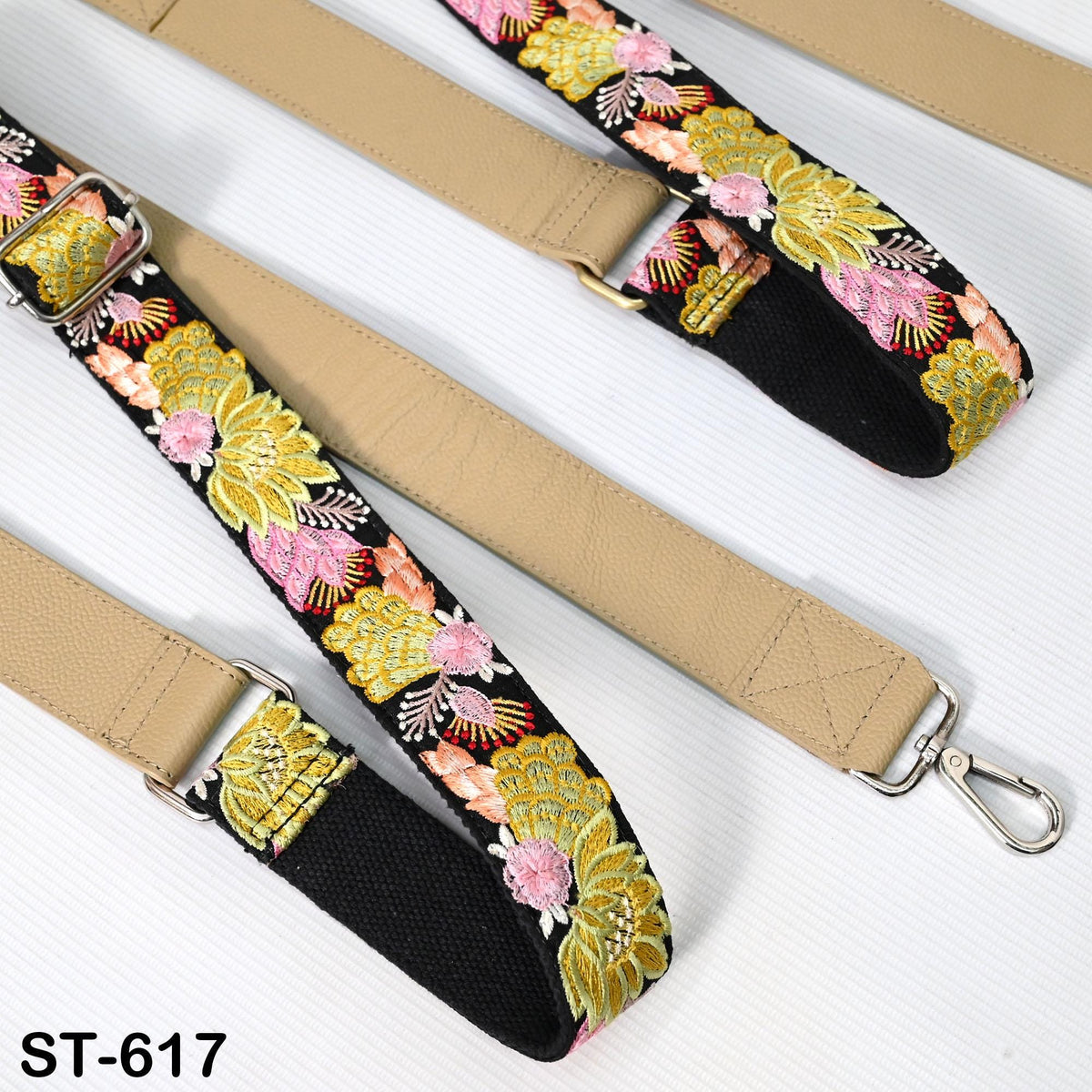 a beige strap with a floral pattern, featuring a metal hook attached to the end. The strap appears to be a handbag strap or strap for a bag.