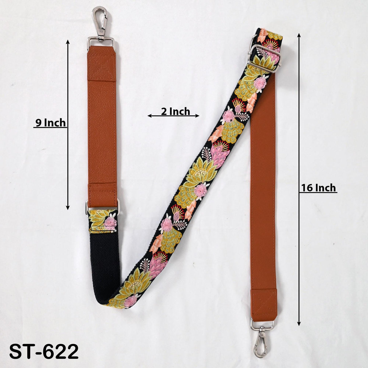 a floral patterned strap with measurements and a metal hook attached to it.