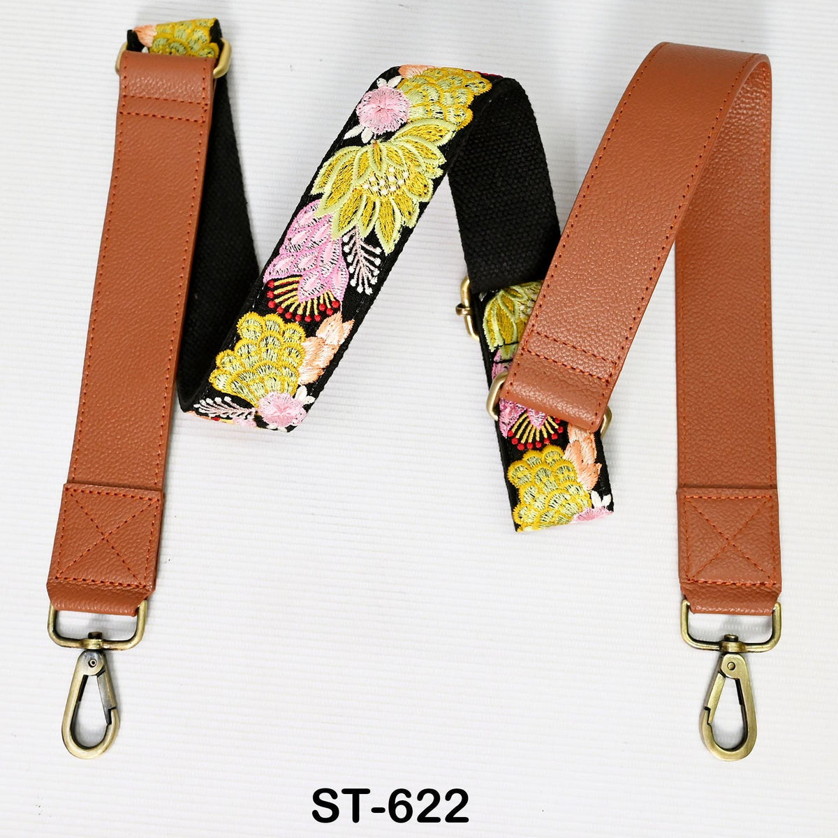 A floral patterned leather strap with a metal hook attached, displayed on a white background.