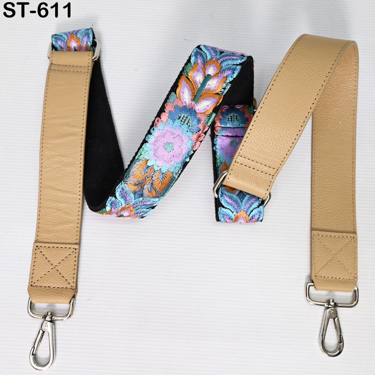 A beige leather strap with a floral pattern, featuring a metal clasp and hook attachment.