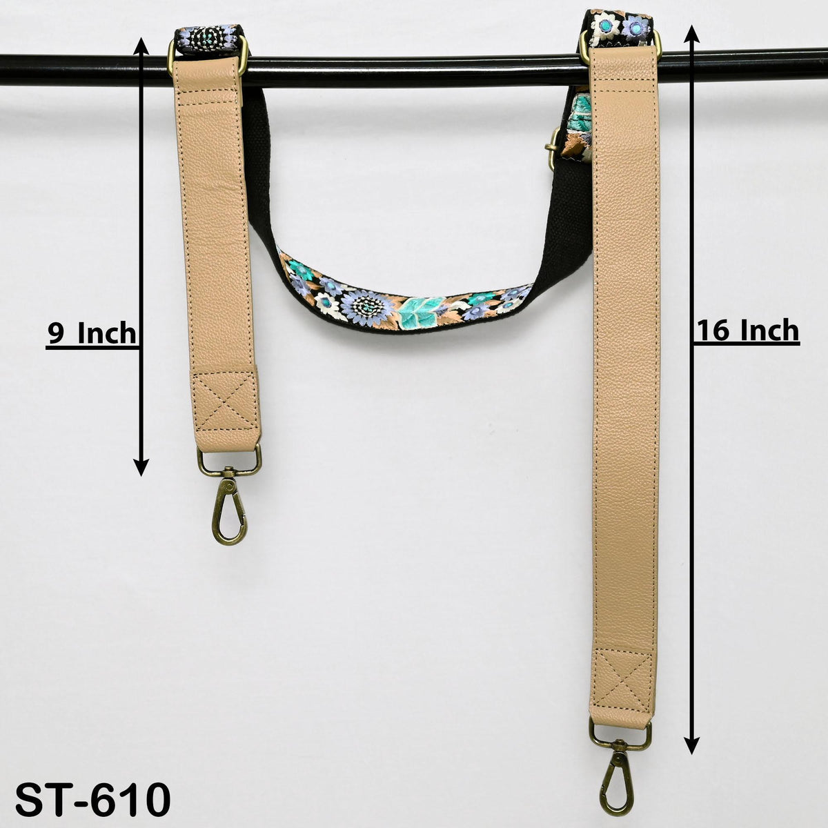 a pair of beige leather straps with floral patterns, hanging on a black bar. The straps are 9 inches long and 16 inches long.
