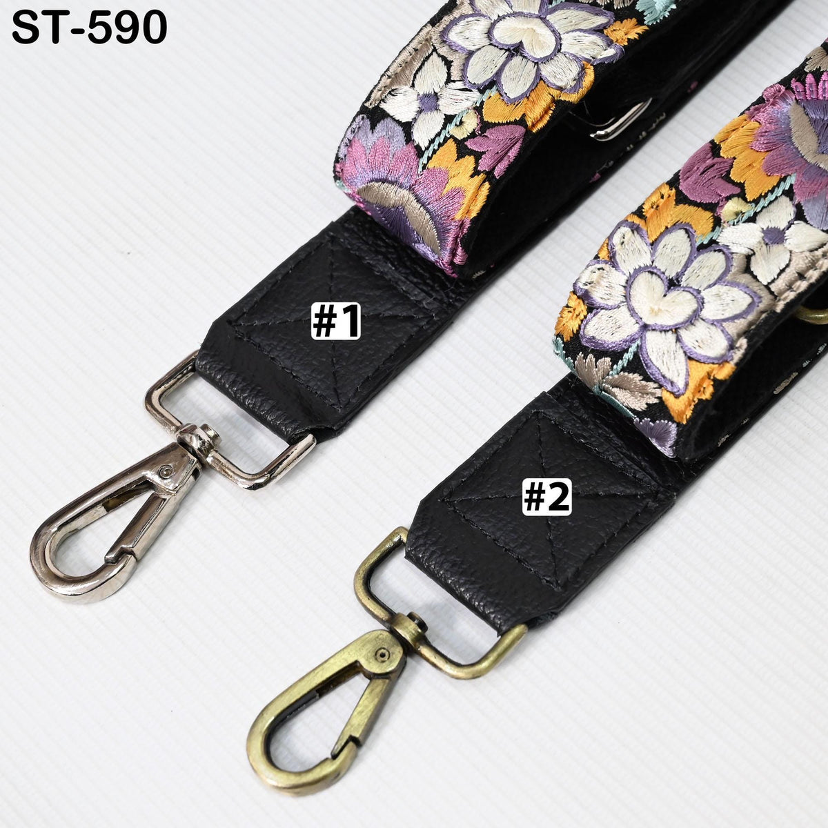 two straps with floral patterns, one with a metal clasp and the other with a metal loop.